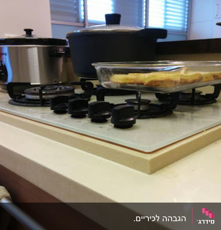 A kitchen countertop with a gas stove and cooking utensils.